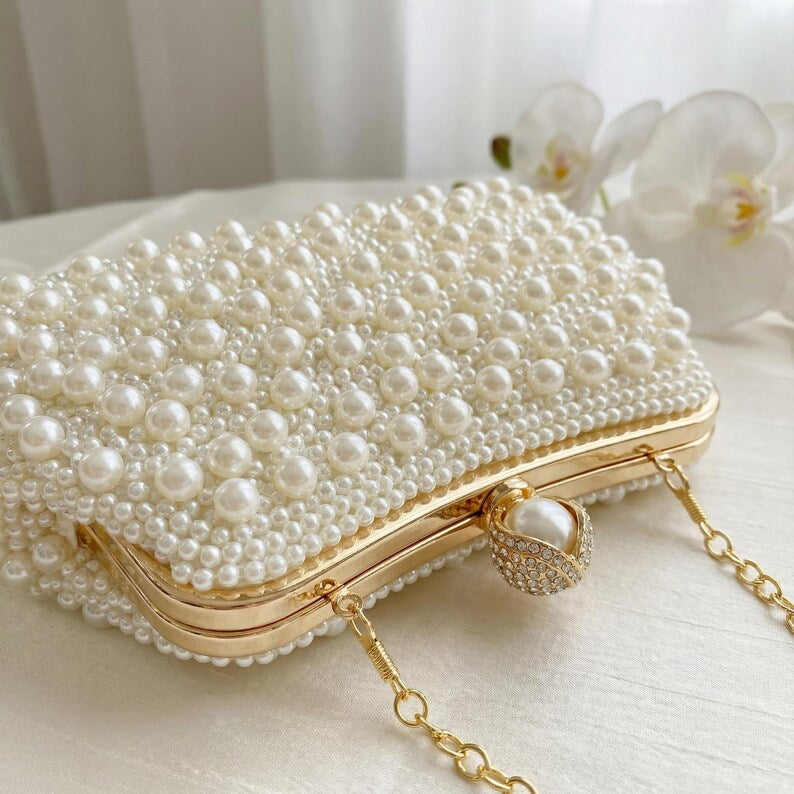 Ivory satin bridal clutch with pearl and bead tassels.
