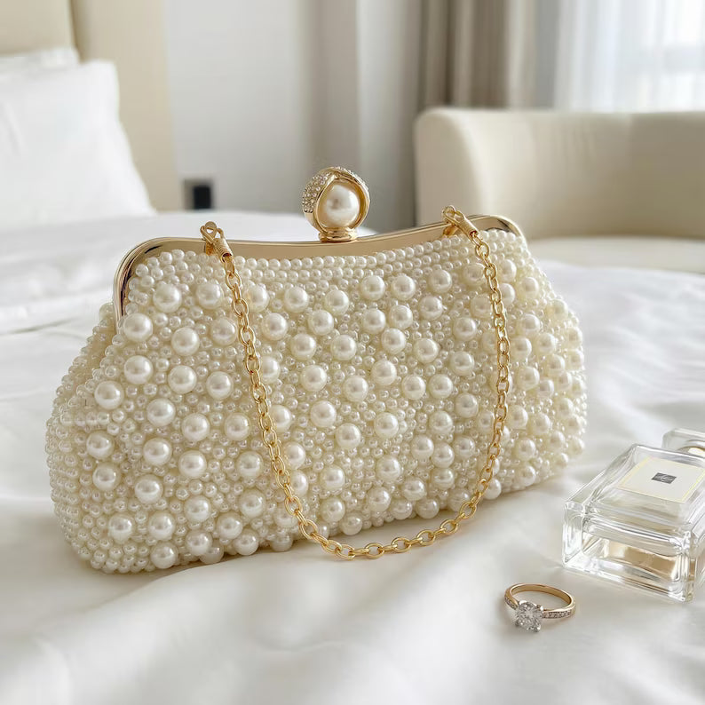 Ivory satin bridal clutch with pearl and bead tassels.