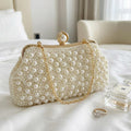Ivory satin bridal clutch with pearl and bead tassels.